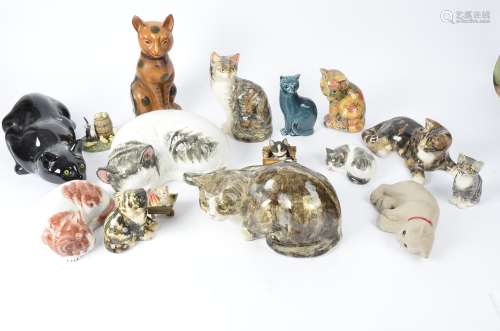 Sixteen figures of cats, to include some examples from the Winstanley pottery, the largest 14cm x