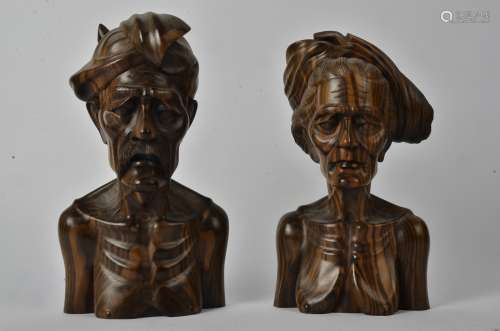 A pair of Indonesian hardwood busts, one male and one female, marked to the base 