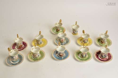 A harlequin group of Continental porcelain cups and saucers, with gilt handles and transfer