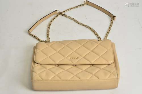 A DKNY designer handbag, of twin chained, quilted fold over form, opening to a black monogrammed