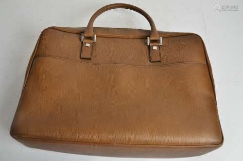 A Salvatore Ferragamo designer handbag, of tanned textured leather, with brown monogrammed interior,