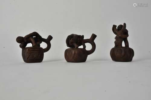 Three South American stoneware erotic figural groups, the tallest 10cm (3)