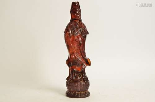 A resin figure of Guanyin, with one hand raised and the other holding a vessel, upon a lotus base,