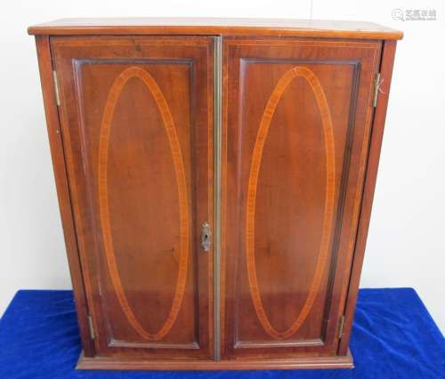 An Edwardian mahogany inlayed two door wall cupboard, with boxwood and satinwood banding, oval