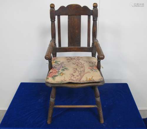 A late 19th century stained beech childs arm chair, with turned arms and supports, loose cushion