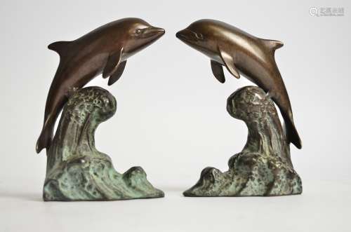 A pair of bronze dolphins, each riding the crest of a wave, height 15.5 cm