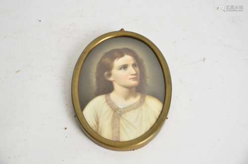 A continental porcelain plaque of a young Jesus, of oval shape, 13cm x 9.5cm