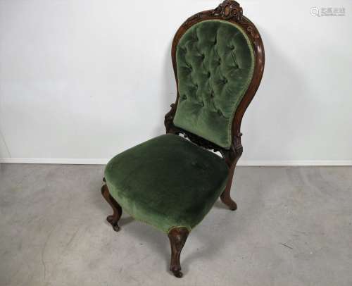 A Victorian walnut framed button backed nursing chair foliate decorated carved frame, raised on