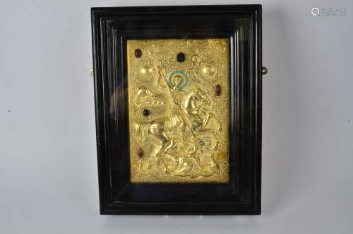 A gilt Russian icon inset with semi-precious stones including turquoise, it's subject a rider on
