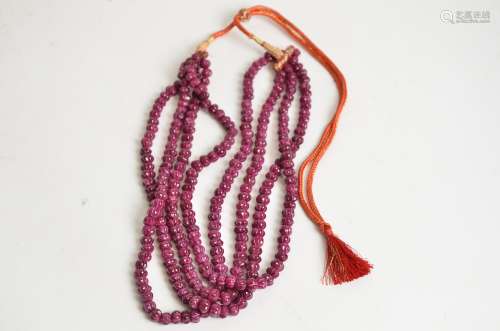 A contemporary Indian four strand ruby bead necklace, length of drop 23cm