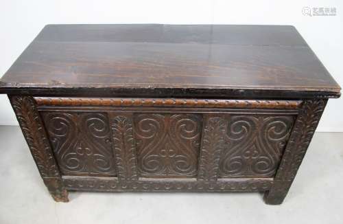 A carved oak panelled coffer, of 18th century origin, candle box to the interior, 127cm x 57cm x