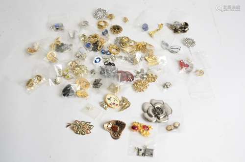 A quantity of costume jewellery, predominantly brooches and earrings, to include a large rose brooch