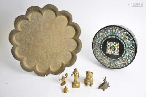 A Middle Eastern brass tray of multi-lobed form, with central figurative decoration and five other