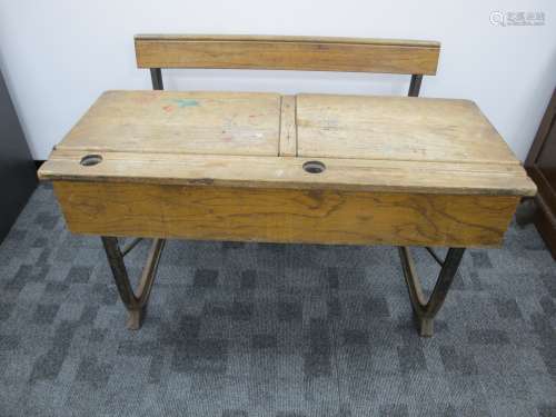 A vintage oak double school desk, lift up desk lids, inkwell holes and pen slots, integrated folding