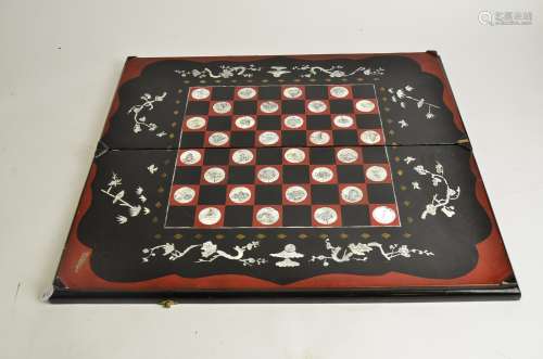 A 20th Century lacquered and mother of pearl Chinese chess and backgammon board, 63cm x 28cm x