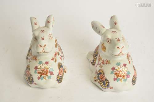 A pair of Chinese Imari rabbits, with heads turned facing backwards, with hand painted decoration of