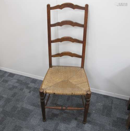 A late 19th century rush seated ladder back chair , oak and elm, turned front stretcher and supports