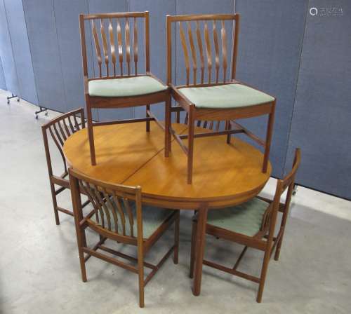 A mid-century teak dining suit, possible Danish design, comprising of an oval draw leaf table with
