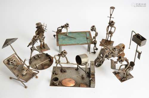 Eight Hinz and Kunst nuts and bolts sculptures, all engaged in industrious or leisurely