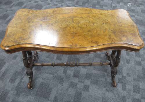 A 19th century burr walnut centre table, figured serpentine shaped moulded top above a shaped