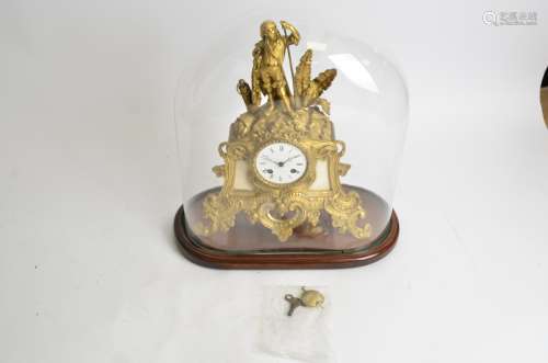 A French mantle clock under glass dome, with gilt surround, raised on two straight and two scrolling