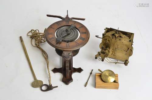 A Black Forest style clock movement, length 37cm, together with another brass clock movement (2)