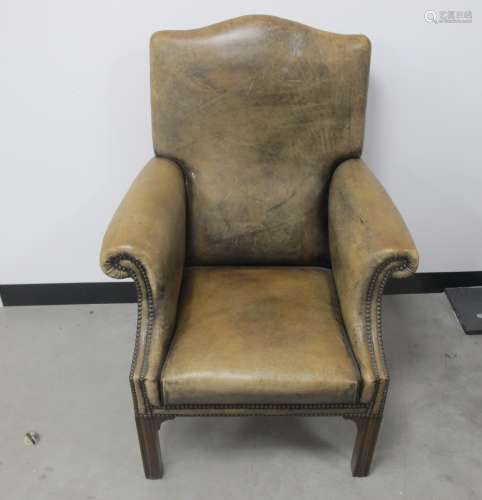 A Georgian style arm chair, mushroom coloured leather upholstery with brass studding, raised
