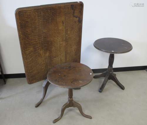 A antique oak rectangular tilt top table, three plank top with a moulded edge, turned column and