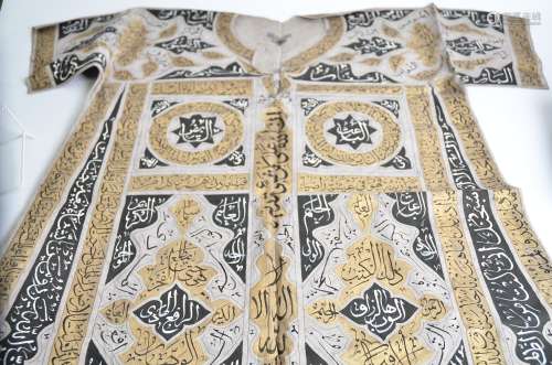 An Islamic ceremonial textile, on a grey ground, with gilt bordering, black and white, multiple