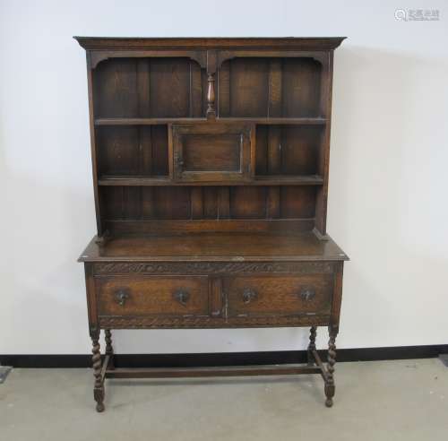 1920s oak dresser, upper section panelled back, two fixed shelfs and a central cupboard, the base