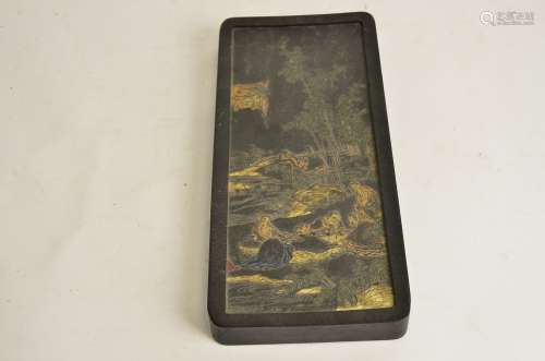 A large Chinese ink block, with raised depiction of elders engaged in gaming in a rocky riverside