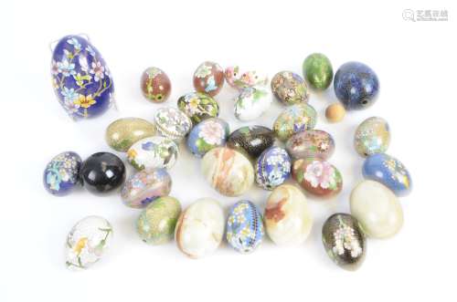 A collection of eggs, to include cloisonné and alabaster examples, (25+)