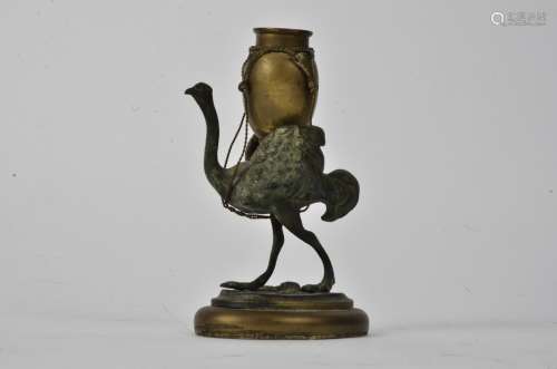 A late 19th Century Bergman style bronze and base metal figure of an ostrich, carrying a vessel on