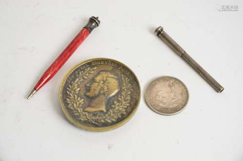 An early 20th Century silver pencil together with a another Bakelite example, a Prince Albert