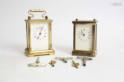 Two brass carriage timepieces, one marked 'Henley', the other 'Dominion', total height of tallest
