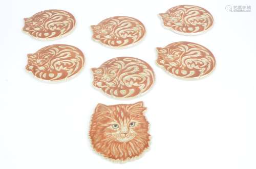 Six stoneware cat coasters, each in the form of a sleeping feline, length 18cm