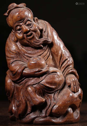 A BAMBOO CARVED FIGURE SHAPED STATUE