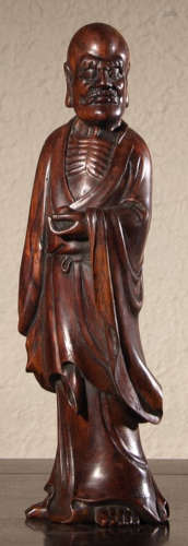 A HUANGHUALI WOOD CARVED BODHIDHARMA STATUE