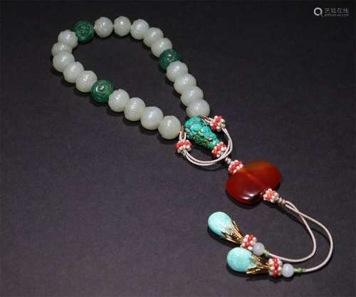 A CHINESE CARVED HETIAN JADE HAND STRING