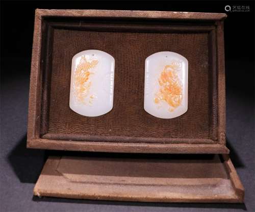 A PAIR OF CHINESE CARVED HETIAN JADE PENDANTS