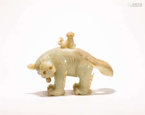 A CHINESE CARVED HETIAN JADE ORNAMENT