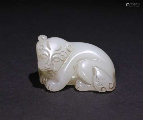 A CHINESE CARVED HETIAN JADE ORNAMENT