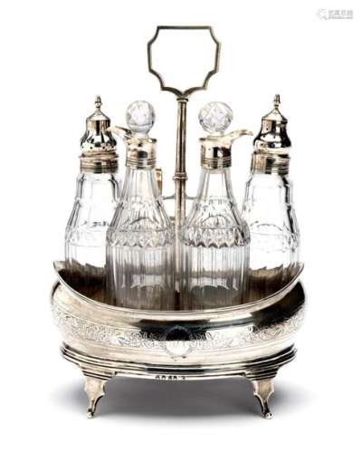 An English silver cruet set with cut glass bottles…