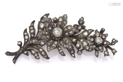 A 14k gold and silver diamond flower brooch