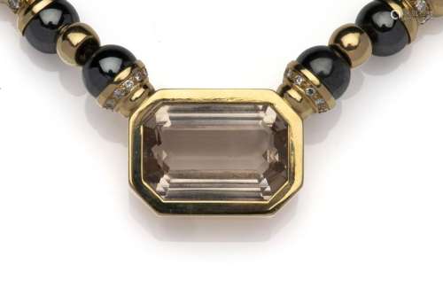 An 18k gold topaz and diamond necklace