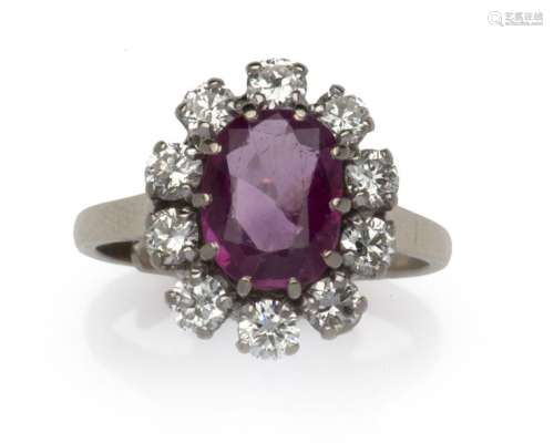 An 18k gold ruby and diamond cluster ring