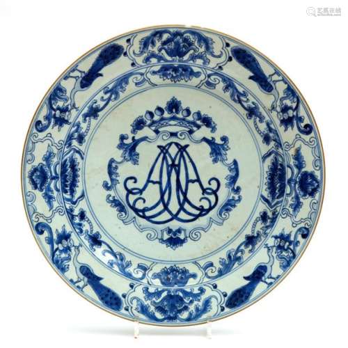 A large blue and white charger with crowned monogr…