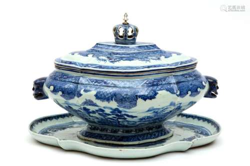 A large blue and white tureen with crown knob and …
