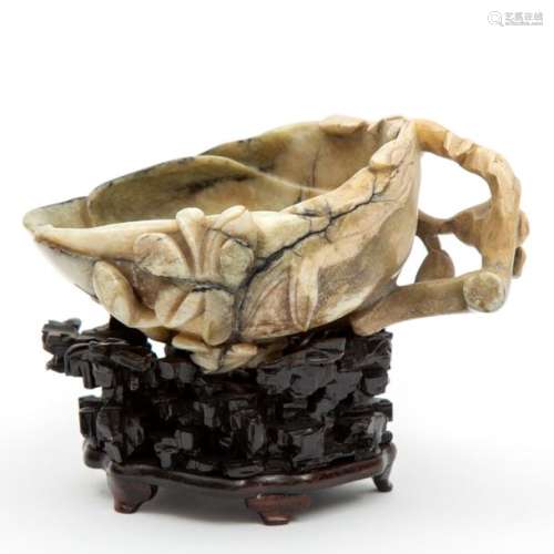 A Chinese carved jade brush washer on wooden base