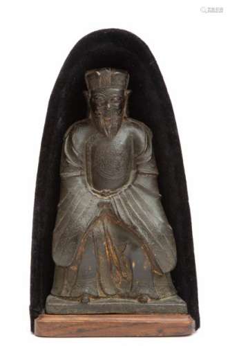 A bronze figure of a seated dignitary